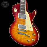 Electric guitar with a sunburst finish on a black background, featuring the Tone Shop logo.