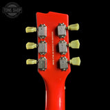 Close-up of a red guitar headstock with tuning pegs on a black background, featuring 'Tone Shop' branding.