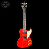 Red electric guitar with a white pickguard on a black background, featuring the Tone Shop logo.