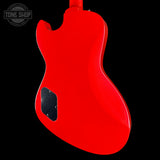 Red electric guitar body with a black pickguard on a black background, featuring 'Tone Shop' logo.
