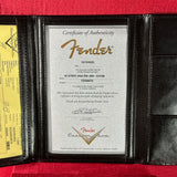 Fender certificate of authenticity in a black leather case on a red background
