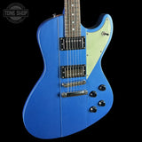 Blue electric guitar with a black pickguard on a black background, featuring the Tone Shop logo.