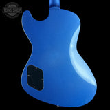 Blue electric guitar body with a black pickguard on a black background, featuring 'Tone Shop' logo.