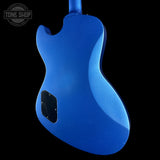 Blue electric guitar body with a black pickguard on a black background, featuring 'Tone Shop' logo.