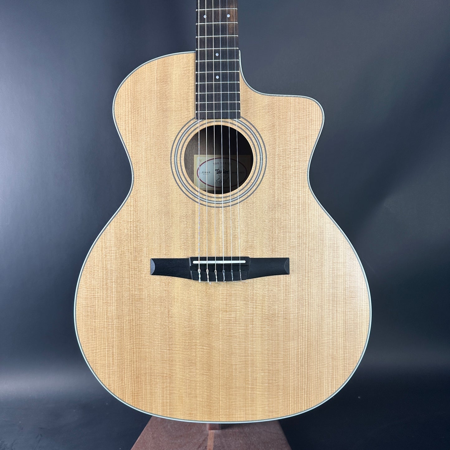 Acoustic guitar with a natural wood finish on a dark background