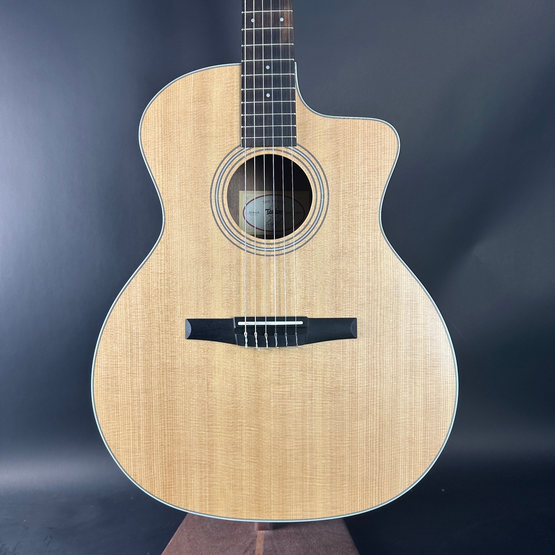 Acoustic guitar with a natural wood finish on a dark background