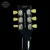 Guitar headstock with tuning pegs and 'Tone Shop' branding on a black background