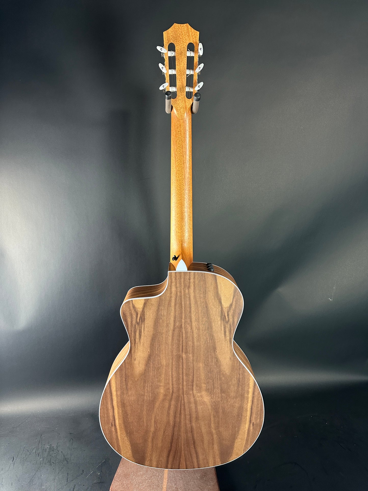 Wooden acoustic guitar on a dark gray background