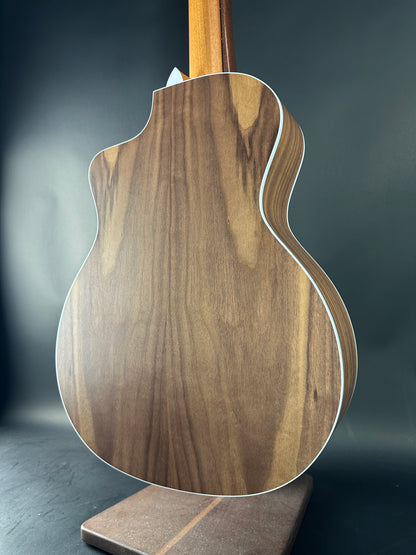 Close-up of a wooden guitar body on a dark background