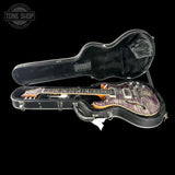 Guitar in a black case with 'Tone Shop' logo in the corner