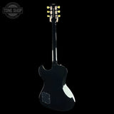 Black electric guitar with a 'Tone Shop' logo in the corner