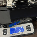 Bass guitar on a digital scale displaying weight
