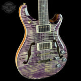 Purple electric guitar with a black background