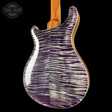 Guitar body with purple and white pattern on a black background, featuring 'Tone Shop' logo.