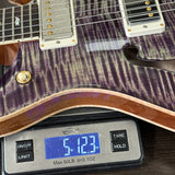 Guitar on a digital scale displaying weight
