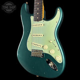 Green electric guitar with a black background