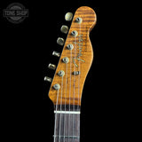 Close-up of a guitar headstock with 'Fender' branding on a black background