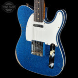 Blue electric guitar with white pickguard on a black background, featuring 'Tone Shop' logo.