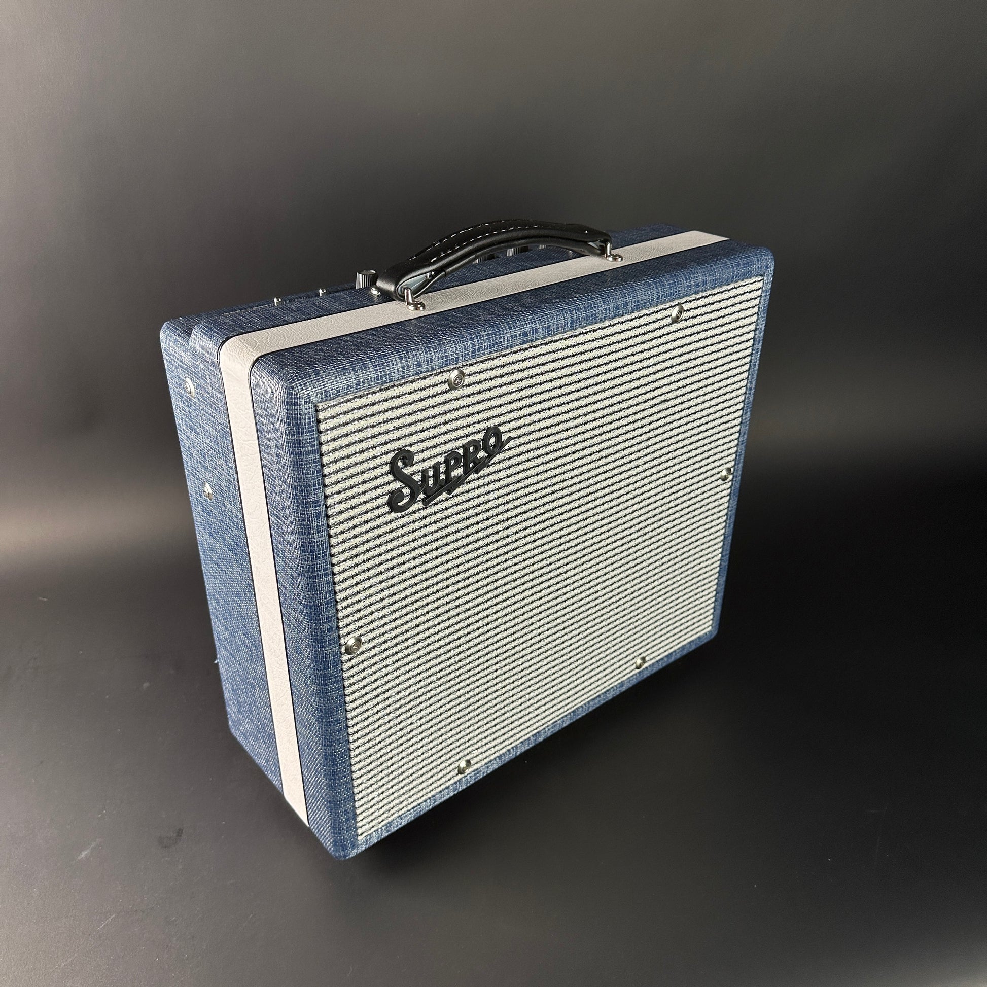 Vintage-style guitar amplifier with 'Supro' branding on a dark background