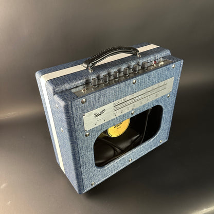 Blue amplifier with a visible brand logo on a gray background