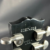 Close-up of a guitar tuning peg with a blurred background