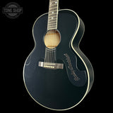 Black acoustic guitar with 'Tone Shop' logo in the corner