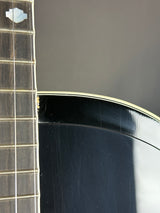 Close-up of a guitar's headstock and tuning pegs with a blurred background