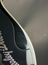 Close-up of a guitar with 'Fender' branding on a blurred background