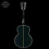 Acoustic guitar with headstock on a black background, featuring 'Tone Shop' logo.