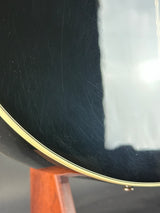 Close-up of a guitar's soundhole with a white pickguard