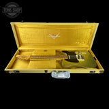 Gold electric guitar in a matching case with Fender logo, Tone Shop branding.