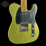 Green glittery electric guitar with a black pickguard on a black background, featuring 'Tone Shop' logo.