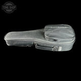A gray padded instrument case, likely for a ukulele or small guitar, shown from a side profile against a solid black background. The case features a top zippered pocket with metal rivets, a carrying handle, and a silver brand tag.