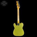 Green electric guitar with a black background