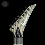 Guitar headstock with 'Jackson' logo on a black background