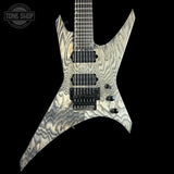 Electric guitar with a unique pattern on a black background, featuring the 'Tone Shop' logo.