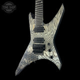 Electric guitar with a unique pattern on a black background, featuring the 'Tone Shop' logo.