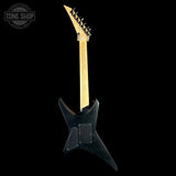 Black electric guitar with a wooden neck on a black background, featuring 'Tone Shop' branding.