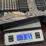 Digital scale displaying weight of a guitar, with a close-up view of the scale and guitar.