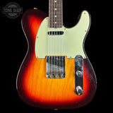 Electric guitar with a sunburst finish on a black background, featuring the Tone Shop logo.