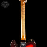Guitar neck with a dark finish on a black background, featuring the Tone Shop logo.