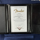 Fender certificate of authenticity in a black leather case on a blue background