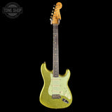 Green electric guitar with a black background