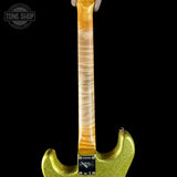 Guitar with a gold glitter finish on a black background, featuring the Tone Shop logo.