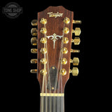 Taylor guitar headstock with gold tuning pegs on a black background