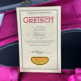 Gretsch Certificate of Authenticity inside a purple guitar case