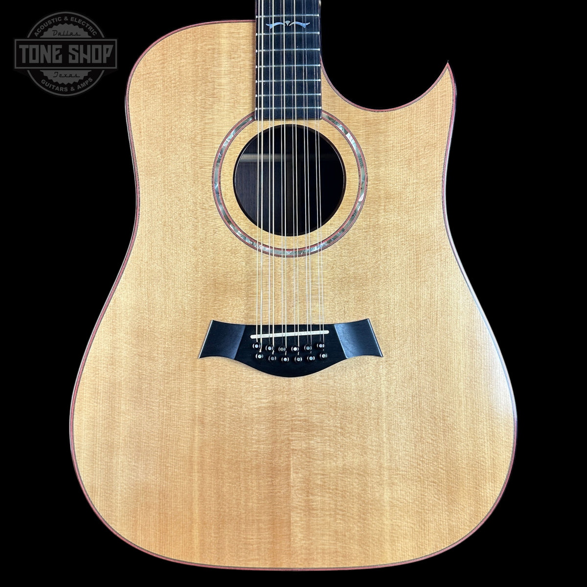 Acoustic guitar with a visible brand logo in the corner