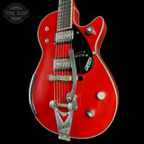 Red electric guitar with Gretsch logo on a black background