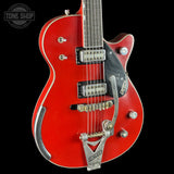 Red electric guitar with a black background