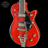 Red electric guitar with Gretsch logo on a black background, featuring the Tone Shop branding.